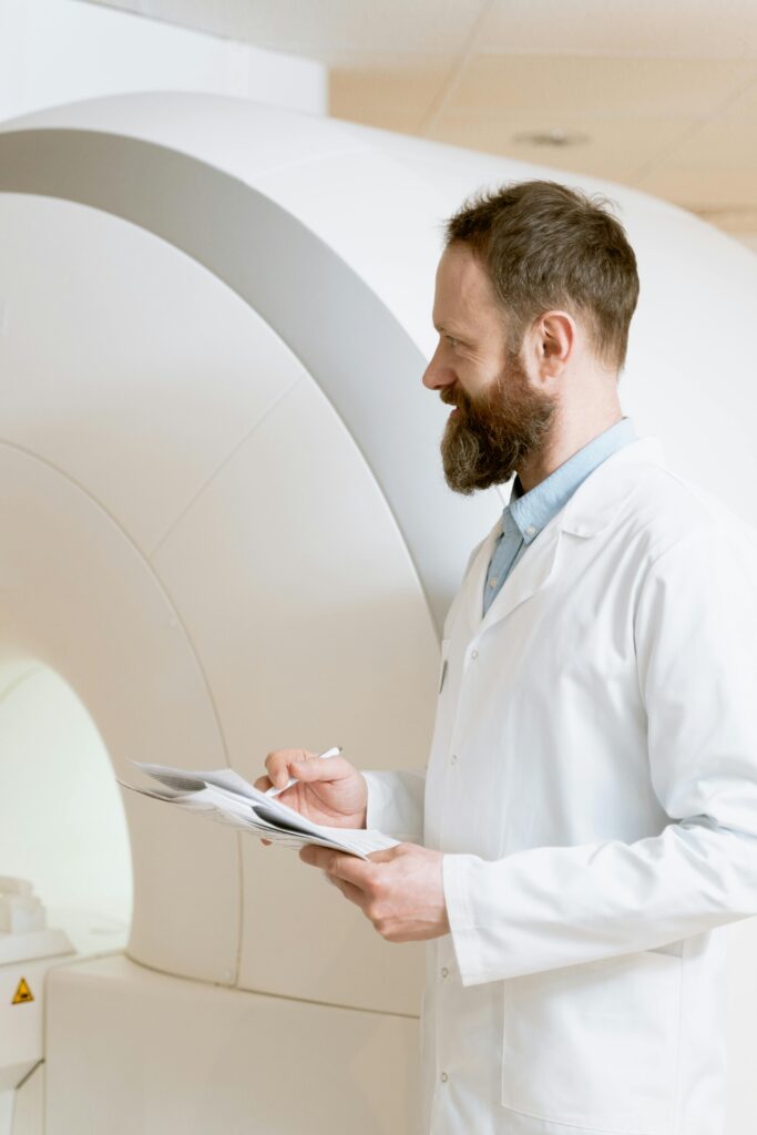 A doctor reviews MRI scan results in a clinical setting.